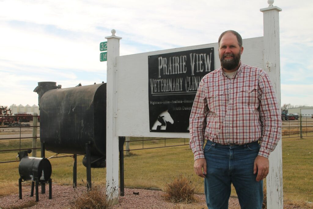 Eric Knock stands by farm sign